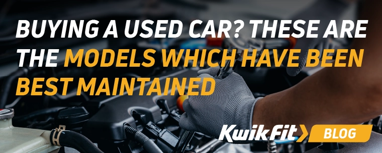 Technician wearing grey gloves checking under the bonnet of a vehicle.