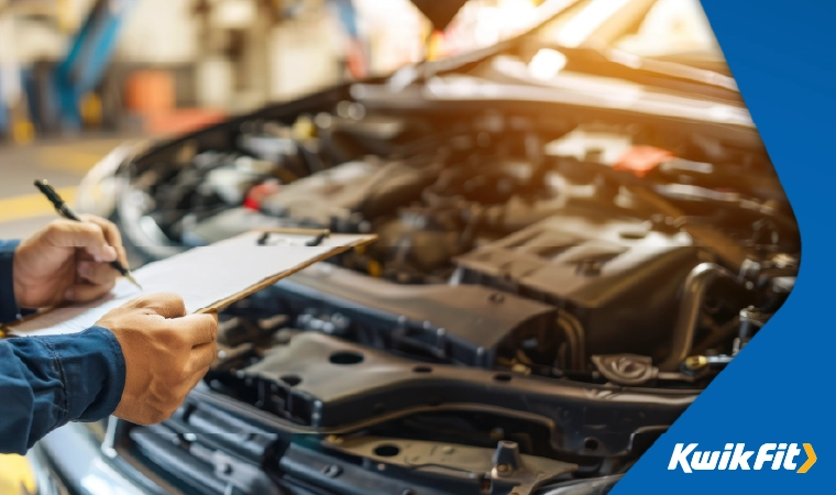 mot tester with a checklist and bonnet open